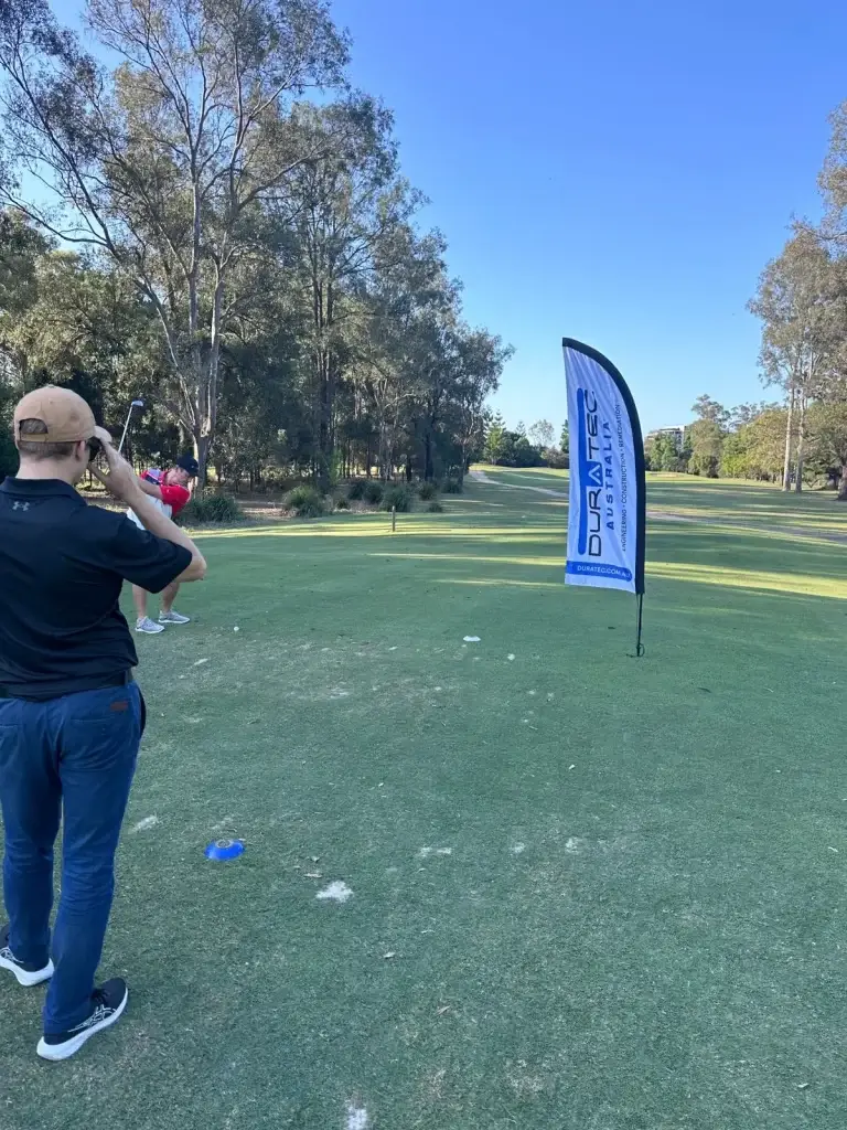 Golf course scene from the Veteran Housing Australia fundraiser event, with GAP Industries team engaged in friendly competition.